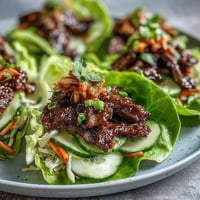 Juicy Korean BBQ beef wraps bursting with crisp lettuce, spicy kimchi, and fresh veggies.